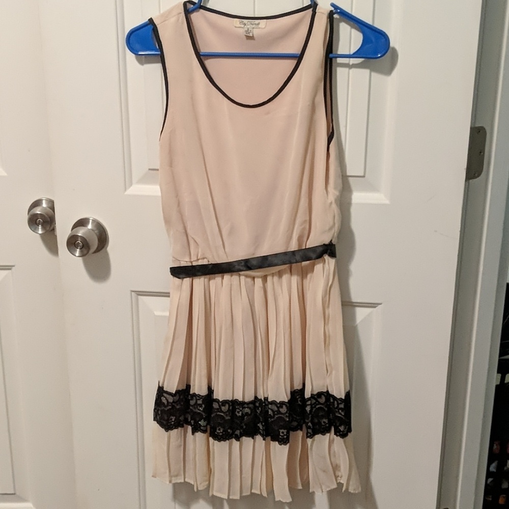 Tan colored dress with black lace at the bottom
